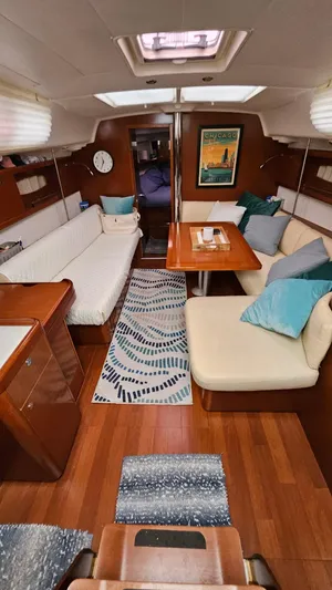 Superstition Yacht Photos Pics Interior of 2012 Beneteau Oceanis 40 sailboat with cozy seating and wooden finishes.