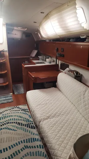 Superstition Yacht Photos Pics Interior of 2012 Beneteau Oceanis 40 sailboat with cozy seating and wooden cabinetry.