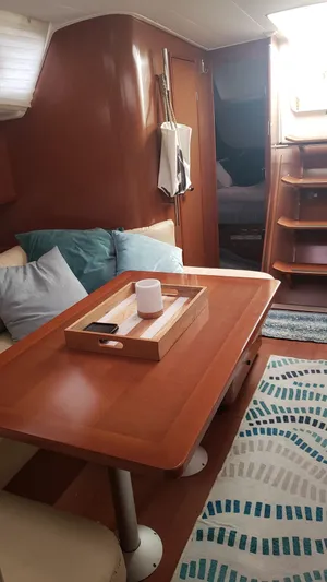 Superstition Yacht Photos Pics Interior of 2012 Beneteau Oceanis 40 sailboat with wooden table and cozy seating.