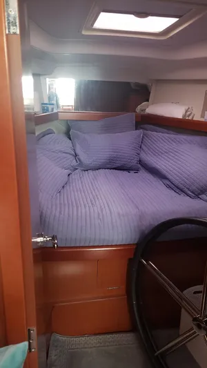 Superstition Yacht Photos Pics Cozy cabin interior of 2012 Beneteau Oceanis 40 sailboat with blue bedding.