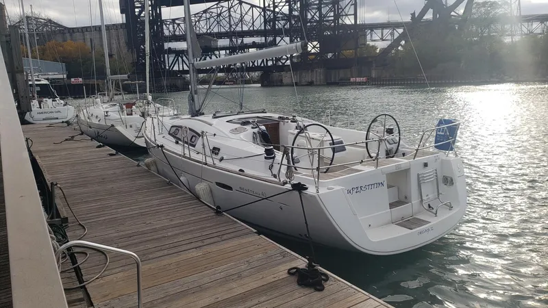 Superstition Yacht Photos Pics 2012 Beneteau Oceanis 40 sailboat docked at a marina with industrial backdrop.