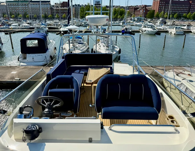  Yacht Photos Pics Flybridge of 2016 Targa 44 yacht with blue seating, docked at marina.