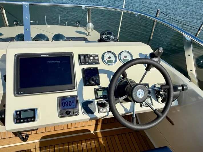  Yacht Photos Pics Helm of 2016 Targa 44 boat with navigation instruments and steering wheel.