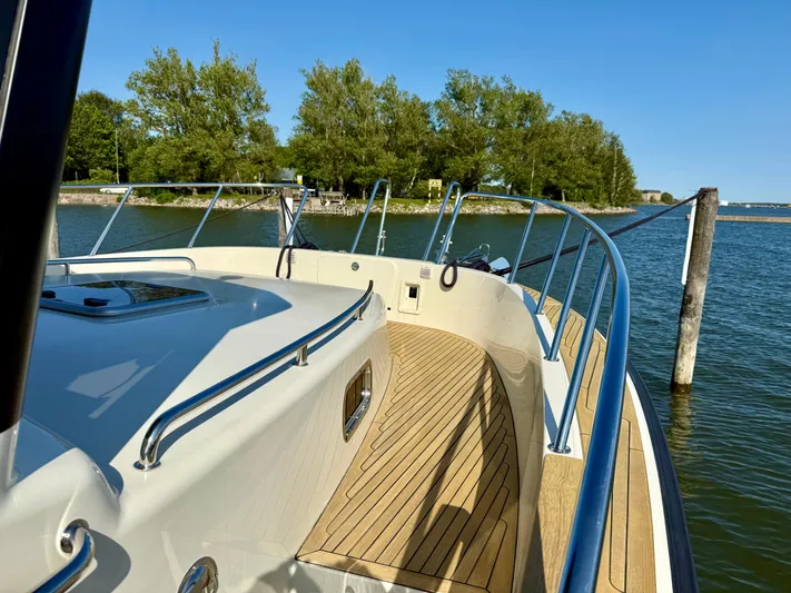  Yacht Photos Pics Targa 44 boat deck, 2016 model, with wooden flooring and scenic water view.