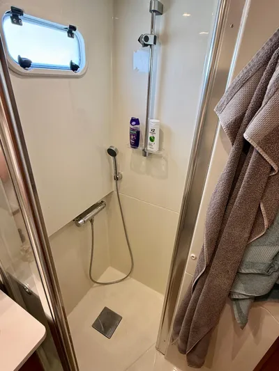  Yacht Photos Pics Compact shower area in a 2016 Targa 44 boat, featuring modern fixtures and a small window.