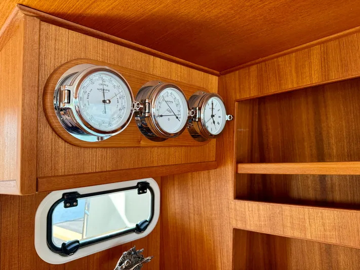  Yacht Photos Pics Wooden interior of 2016 Targa 44 boat with nautical instruments and window.