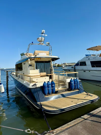  Yacht Photos Pics 2016 Targa 44 yacht docked, featuring a spacious deck and sleek design under clear blue skies.