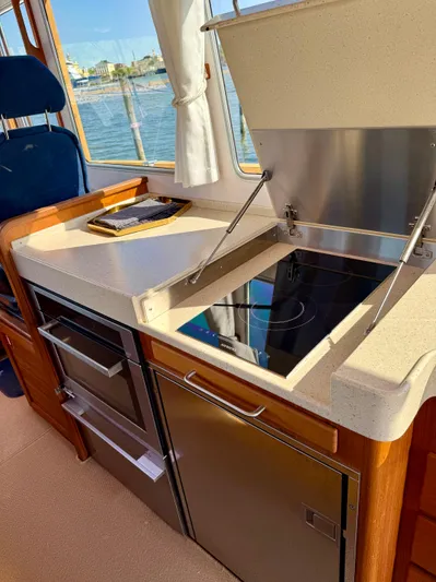  Yacht Photos Pics 2016 Targa 44 yacht kitchen with stove, oven, and scenic window view.