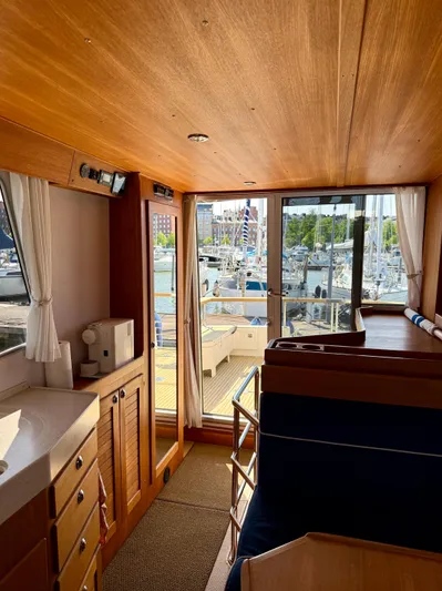  Yacht Photos Pics Interior of 2016 Targa 44 yacht with wooden finish, marina view through windows.