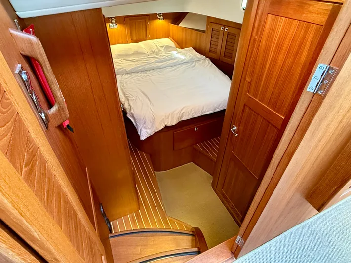  Yacht Photos Pics Cozy cabin interior of 2016 Targa 44 yacht with wooden finish and comfortable bed.