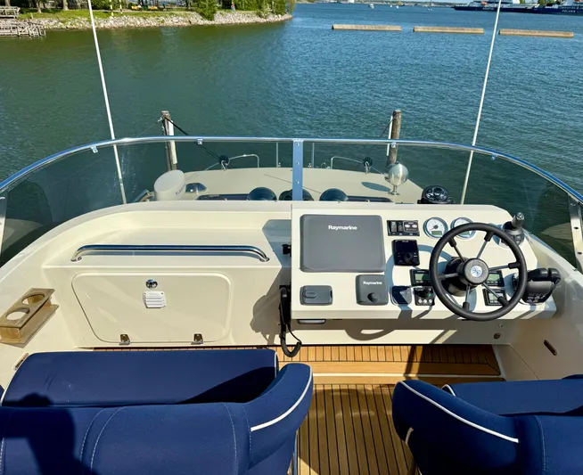  Yacht Photos Pics Helm of 2016 Targa 44 boat with navigation equipment and blue seating.