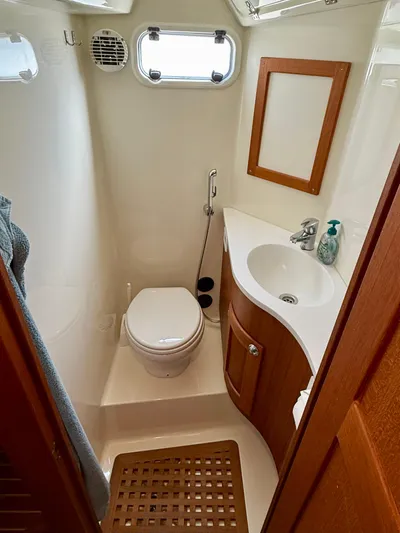  Yacht Photos Pics Compact bathroom in 2016 Targa 44 boat with wooden accents and modern fixtures.