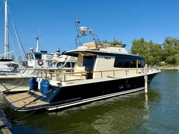  Yacht Photos Pics 2016 Targa 44 yacht docked in a marina under clear blue skies.