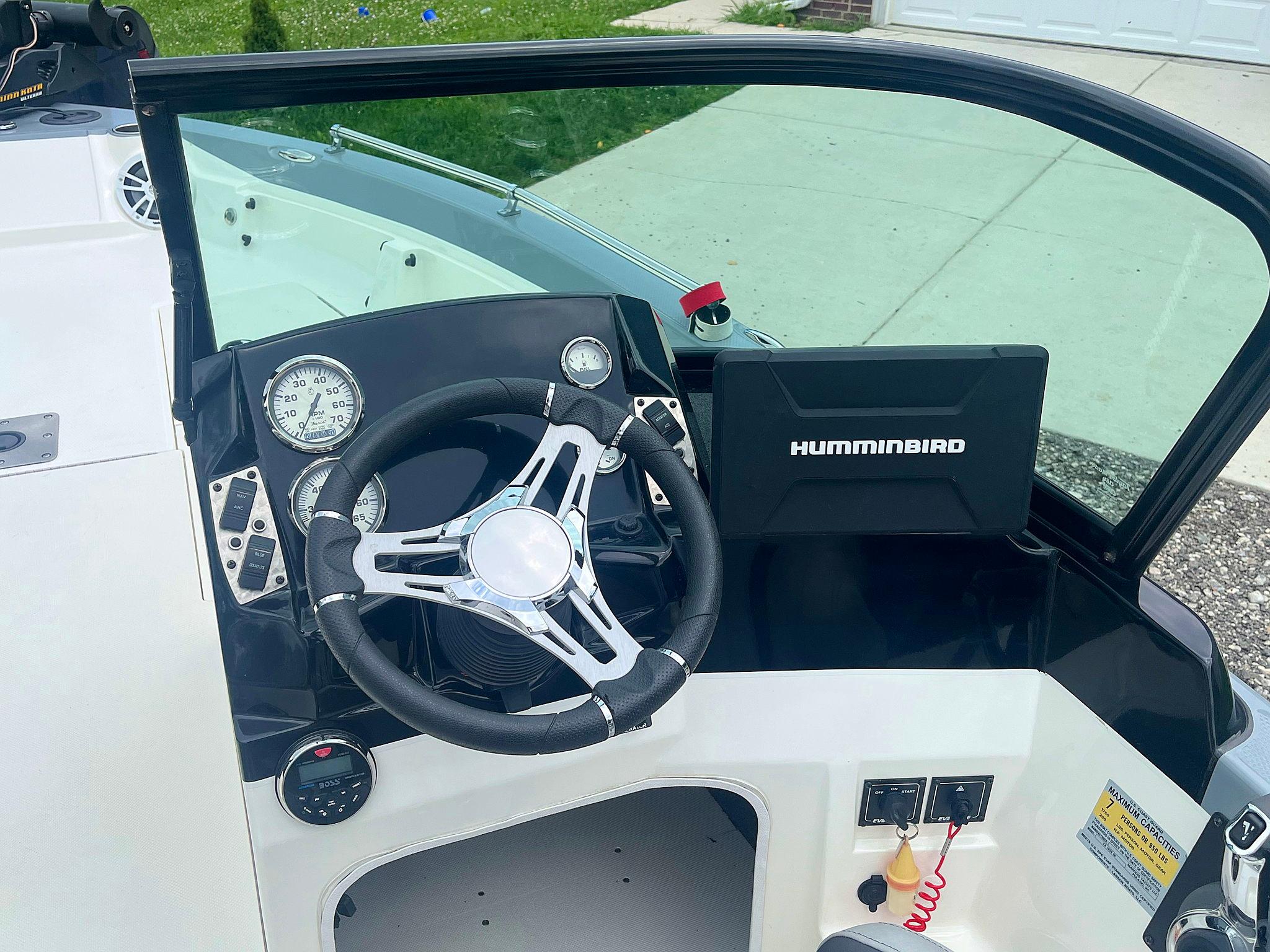 2018 Larson 1850 FX DC boat dashboard with steering wheel and Humminbird navigation system.