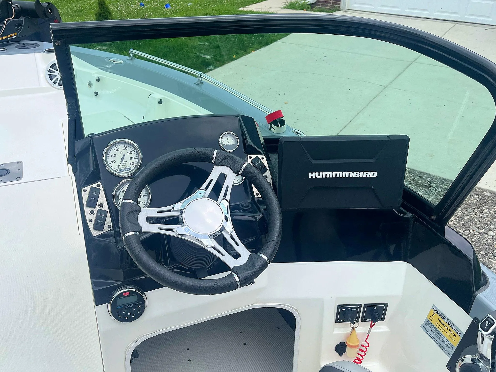 2018 Larson 1850 FX DC boat dashboard with steering wheel and Humminbird navigation system.