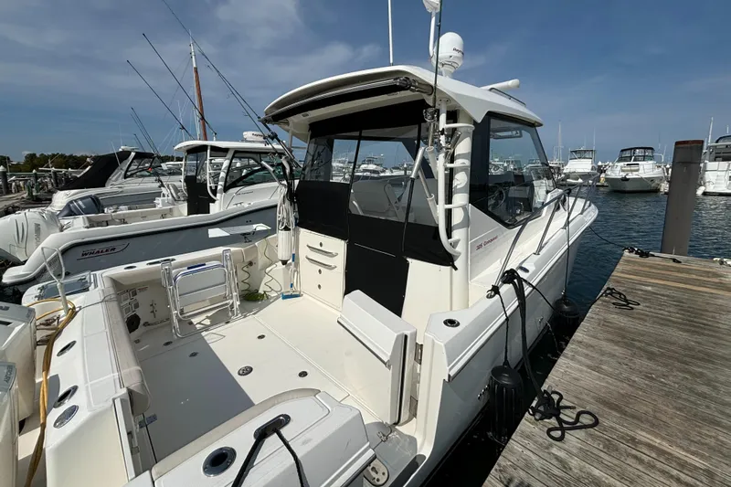 Yacht Photos Pics 2020 Boston Whaler 325 Conquest Pilothouse docked at marina, clear sky background.
