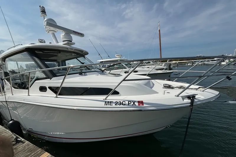  Yacht Photos Pics 2020 Boston Whaler 325 Conquest Pilothouse docked in marina, side view.