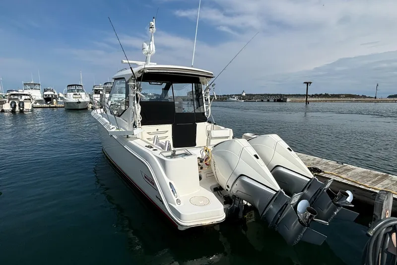  Yacht Photos Pics 2020 Boston Whaler 325 Conquest Pilothouse docked with twin outboard engines.