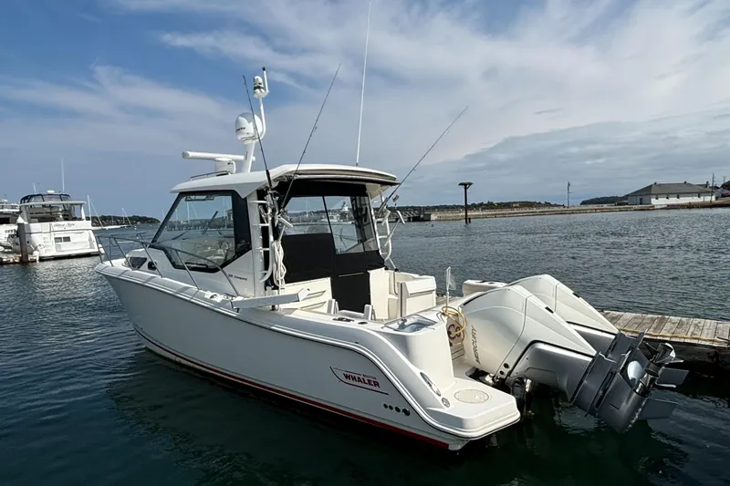  Yacht Photos Pics 2020 Boston Whaler 325 Conquest Pilothouse docked on calm water.