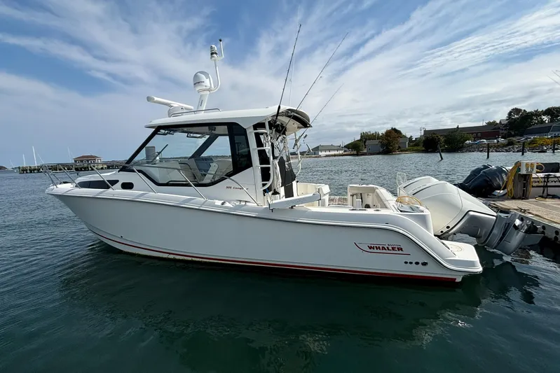  Yacht Photos Pics 2020 Boston Whaler 325 Conquest Pilothouse boat docked on calm water.