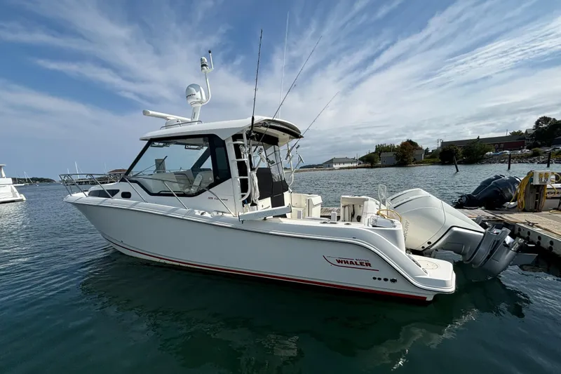  Yacht Photos Pics 2020 Boston Whaler 325 Conquest Pilothouse boat docked on calm water.