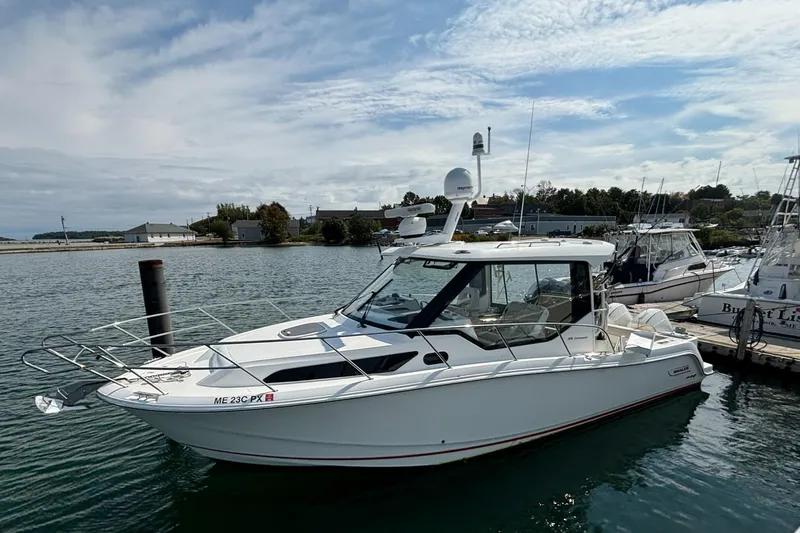  Yacht Photos Pics 2020 Boston Whaler 325 Conquest Pilothouse docked in a marina under a partly cloudy sky.