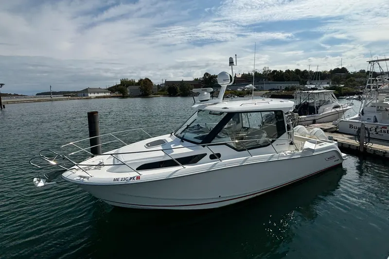  Yacht Photos Pics 2020 Boston Whaler 325 Conquest Pilothouse docked in a marina.