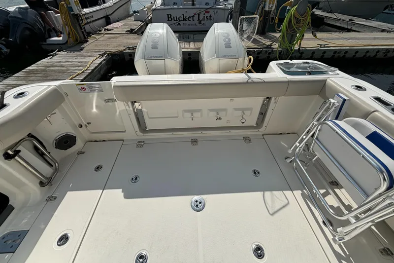  Yacht Photos Pics 2020 Boston Whaler 325 Conquest Pilothouse boat deck with twin engines at dock.