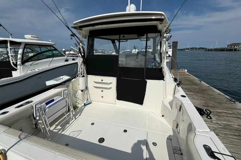  Yacht Photos Pics 2020 Boston Whaler 325 Conquest Pilothouse docked, showcasing spacious cockpit and sleek design.