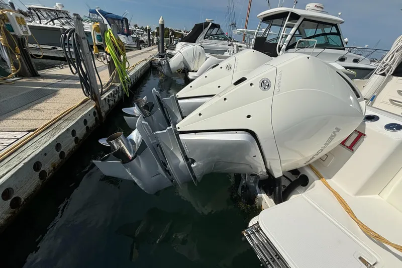  Yacht Photos Pics 2020 Boston Whaler 325 Conquest Pilothouse with dual outboard engines docked at marina.