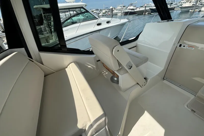  Yacht Photos Pics Interior of 2020 Boston Whaler 325 Conquest Pilothouse, featuring seating and helm area.