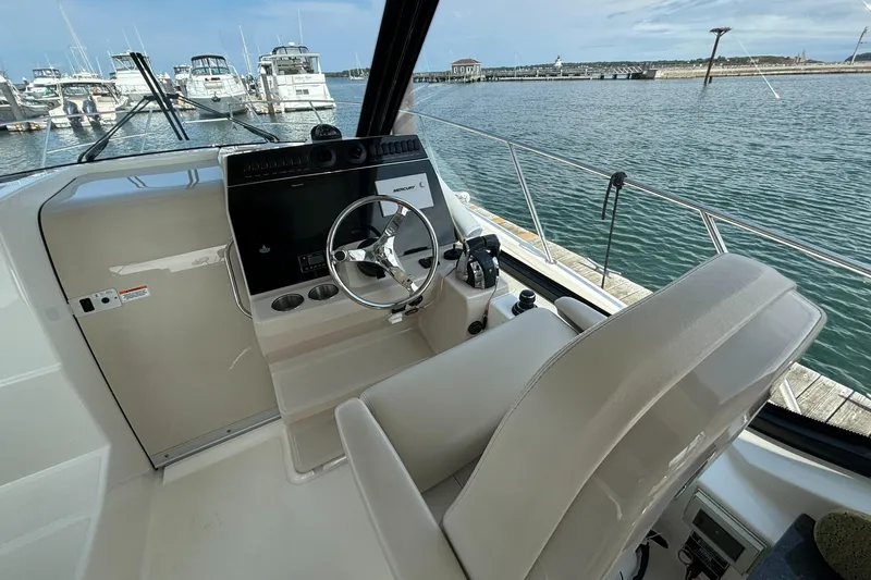  Yacht Photos Pics 2020 Boston Whaler 325 Conquest Pilothouse helm with marina view.