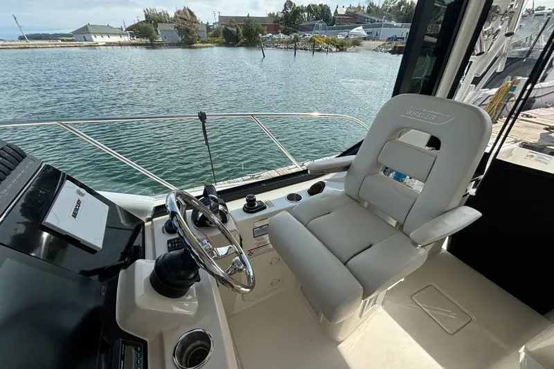  Yacht Photos Pics 2020 Boston Whaler 325 Conquest Pilothouse helm with luxurious seating and scenic water view.