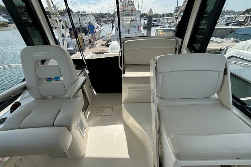  Yacht Photos Pics Interior of 2020 Boston Whaler 325 Conquest Pilothouse, featuring plush seating and modern design.