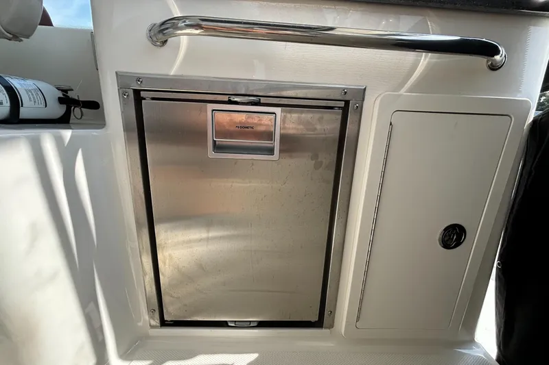  Yacht Photos Pics 2020 Boston Whaler 325 Conquest Pilothouse interior with stainless steel compartment and safety equipment.