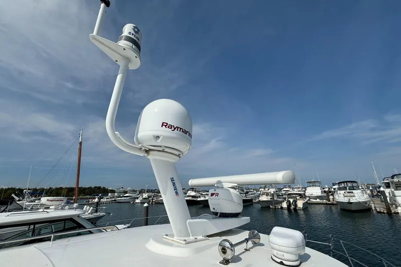  Yacht Photos Pics Boston Whaler 325 Conquest Pilothouse 2020 with radar equipment in a marina setting.