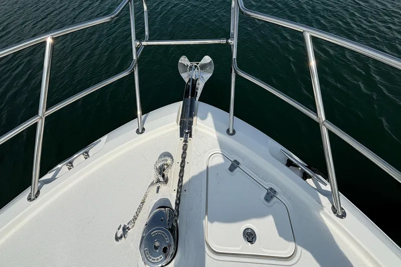  Yacht Photos Pics Bow of 2020 Boston Whaler 325 Conquest Pilothouse with anchor and railing.