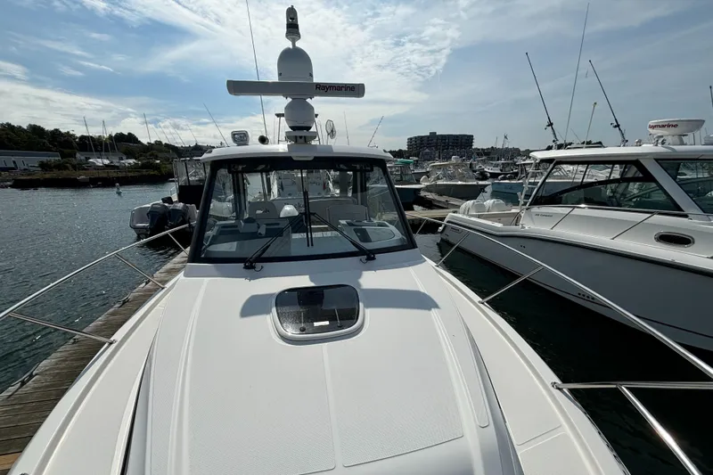  Yacht Photos Pics 2020 Boston Whaler 325 Conquest Pilothouse docked at marina under cloudy sky.