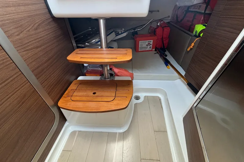 Yacht Photos Pics Interior of 2020 Boston Whaler 325 Conquest Pilothouse with wooden steps and storage.