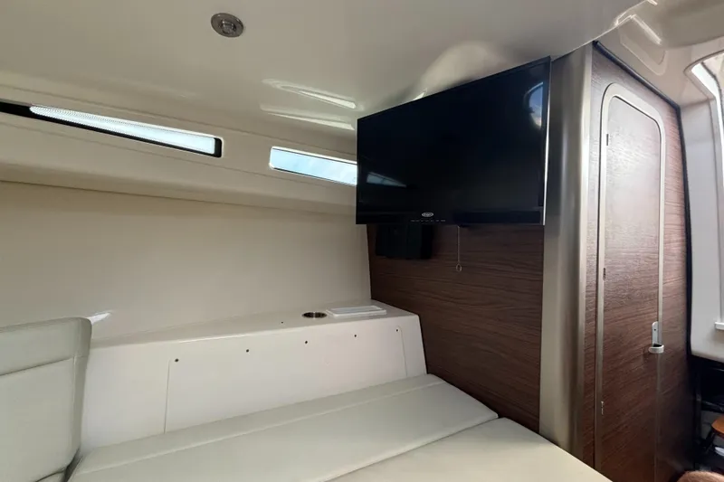  Yacht Photos Pics Interior of 2020 Boston Whaler 325 Conquest Pilothouse with TV and seating area.