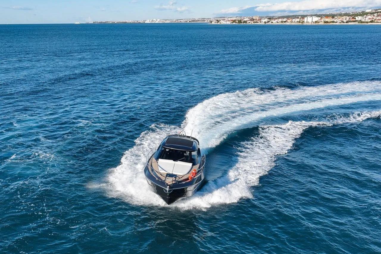 2023 Focus Power 36 yacht cruising on open blue sea near coastline.