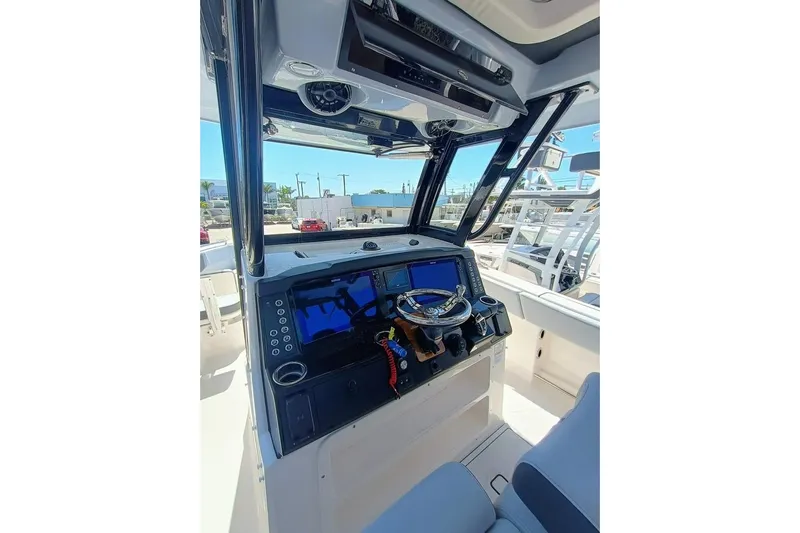 300-115 Yacht Photos Pics 2025 Robalo 300 boat cockpit with modern navigation system and steering wheel.