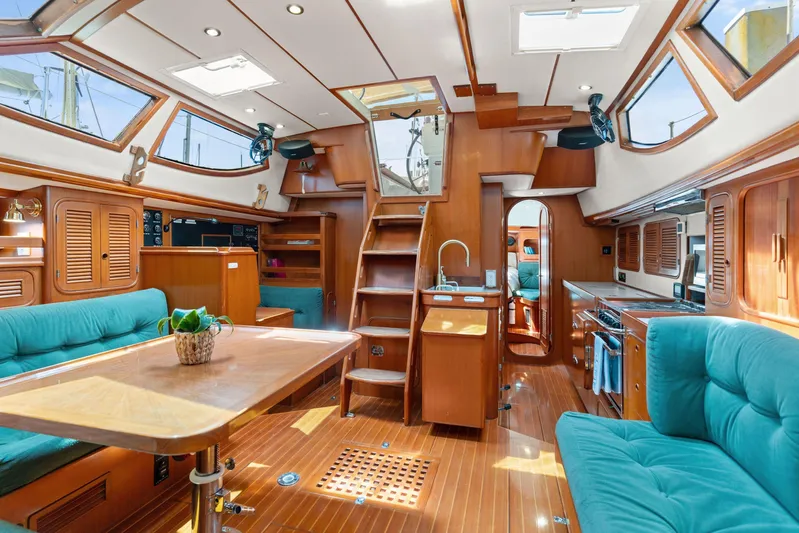 Callahan Yacht Photos Pics Luxurious 2000 Ta Shing Taswell 44 All Season yacht interior with wood finish and teal seating.