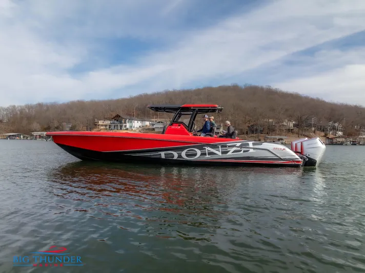  Yacht Photos Pics 2024 Donzi 39 VRZ boat on a lake with a scenic background.