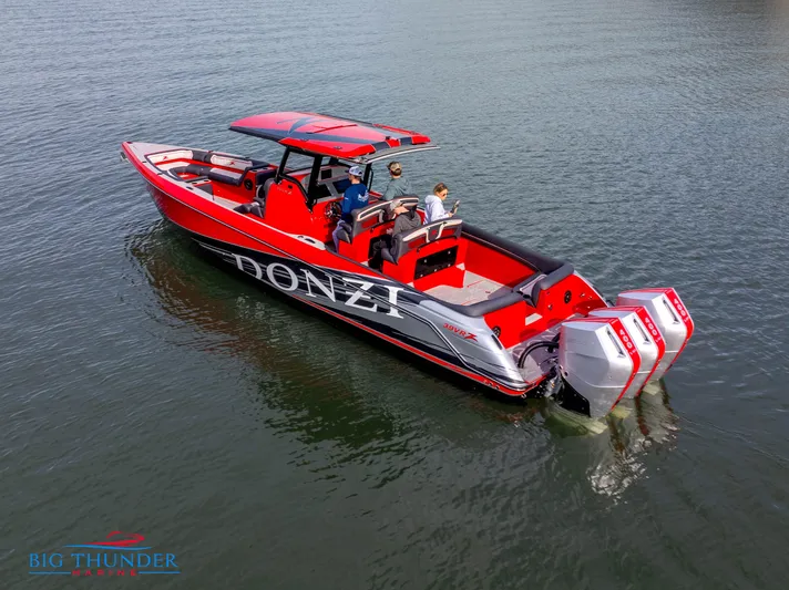  Yacht Photos Pics 2024 Donzi 39 VRZ boat on water, red and black design, triple outboard engines.
