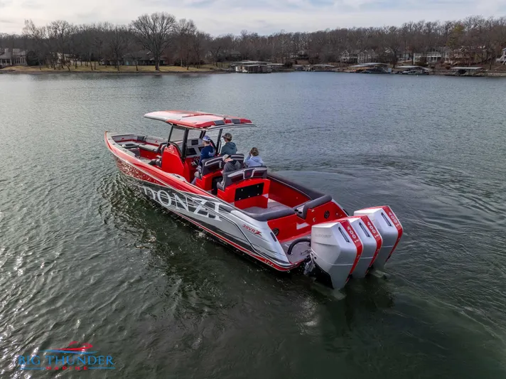  Yacht Photos Pics 2024 Donzi 39 VRZ boat cruising on a lake with triple outboard engines.