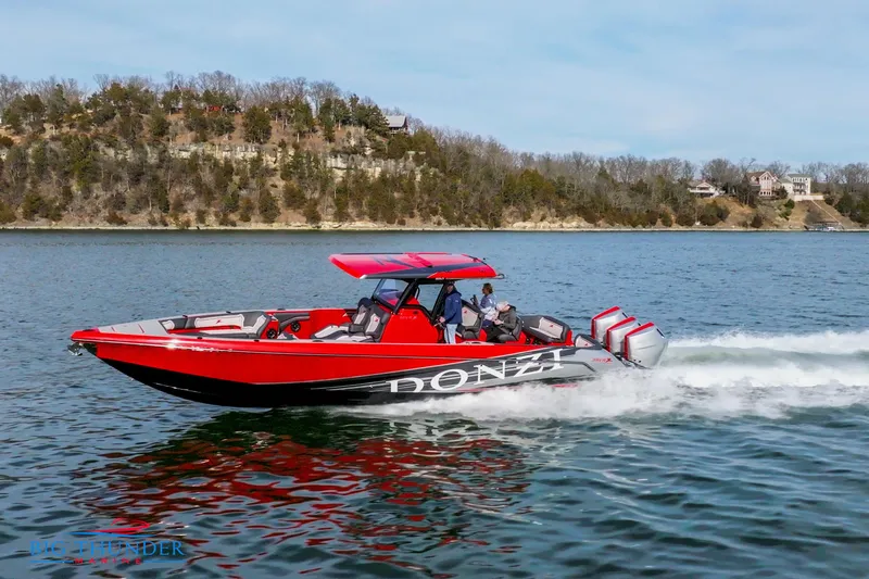  Yacht Photos Pics 2024 Donzi 39 VRZ speedboat cruising on a lake.