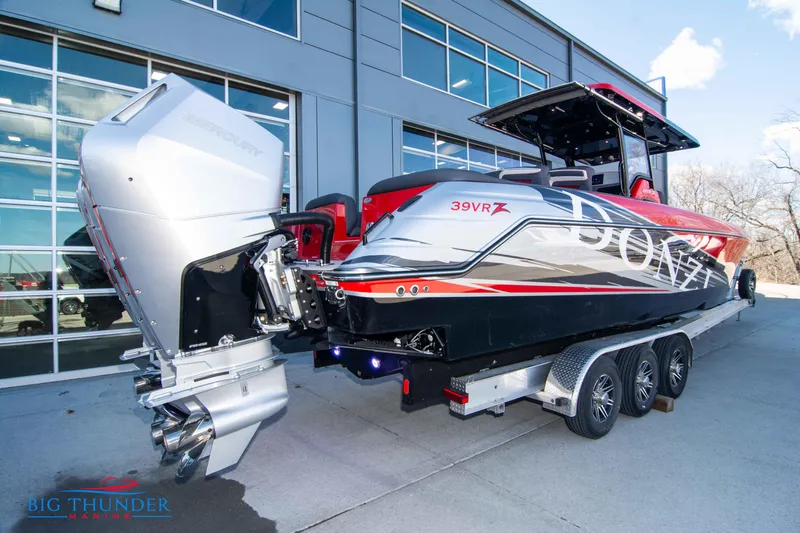  Yacht Photos Pics 2024 Donzi 39 VRZ powerboat on a trailer outside a modern building.