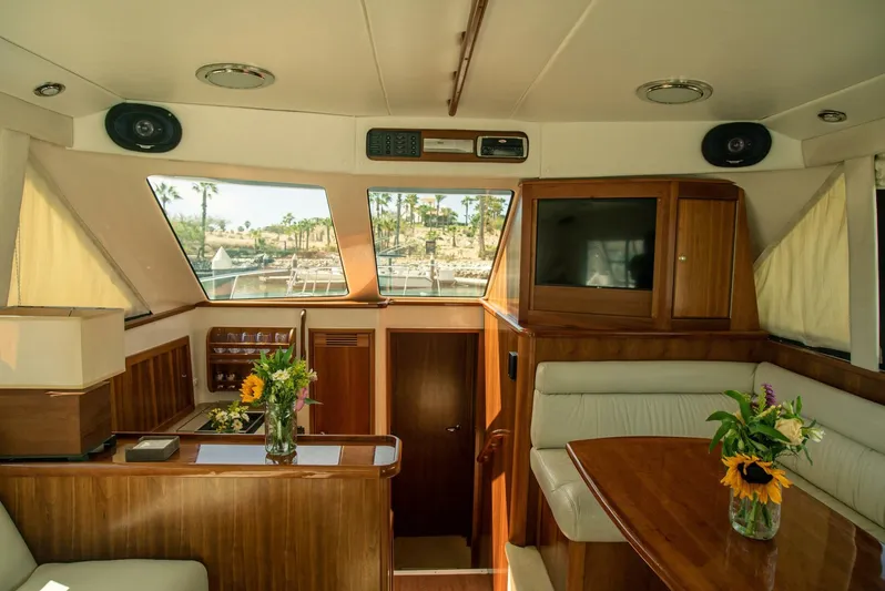 Skiesta Yacht Photos Pics Interior of 2002 Riviera 40 Flybridge yacht with wood finishes and floral decor.