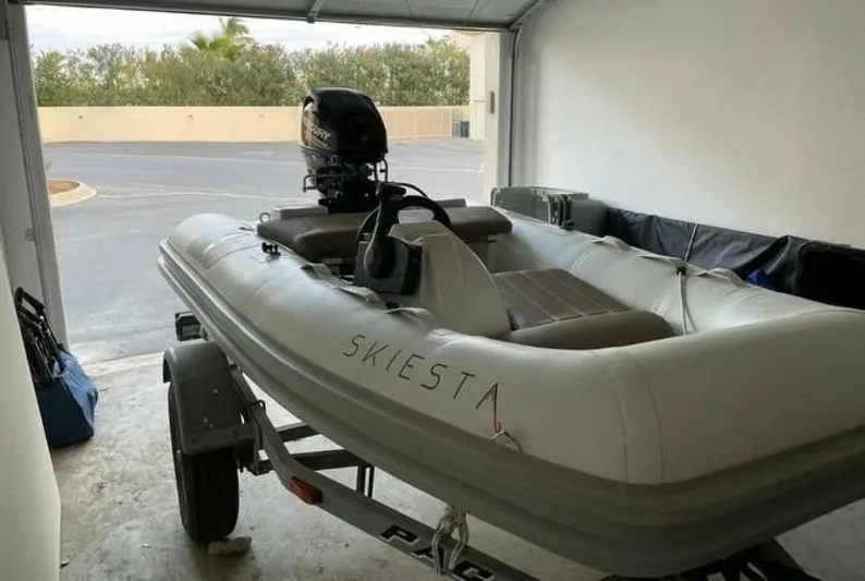 Skiesta Yacht Photos Pics Inflatable boat on trailer in garage, Riviera 40 Flybridge, 2002 model.